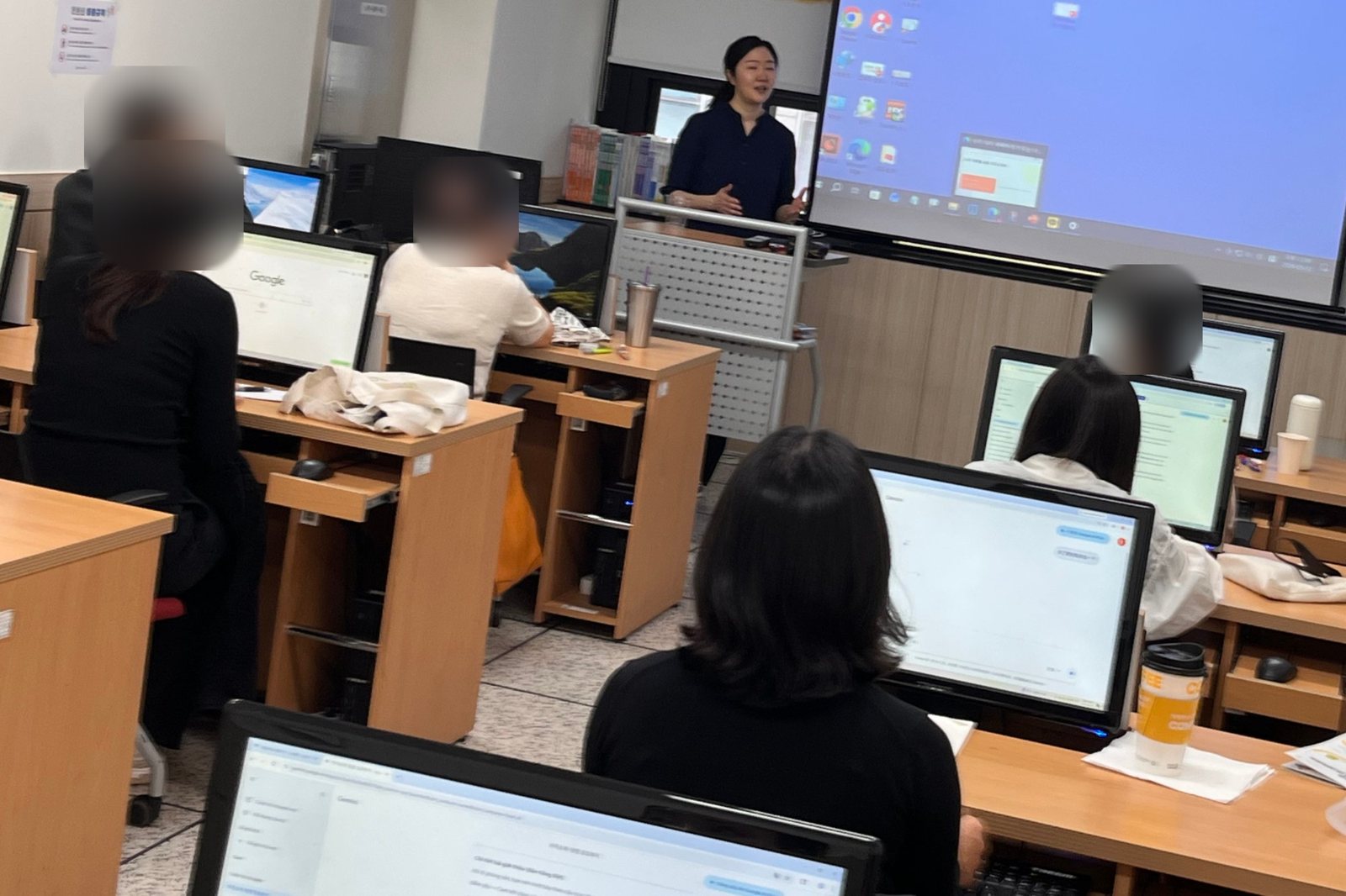 강사가 스크린 앞에서 설명하는 모습